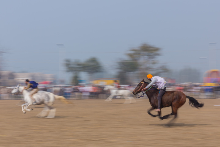 Bare back rider egging on his horse to go faster