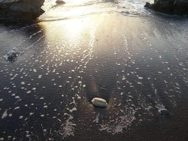 The dark sand at Devka Beach