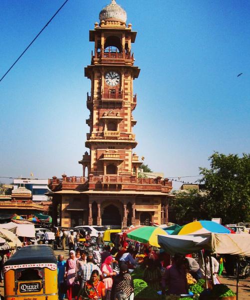 A bustling market at the base of a monument