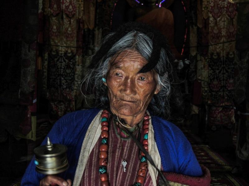 Monpa woman with a prayer wheel