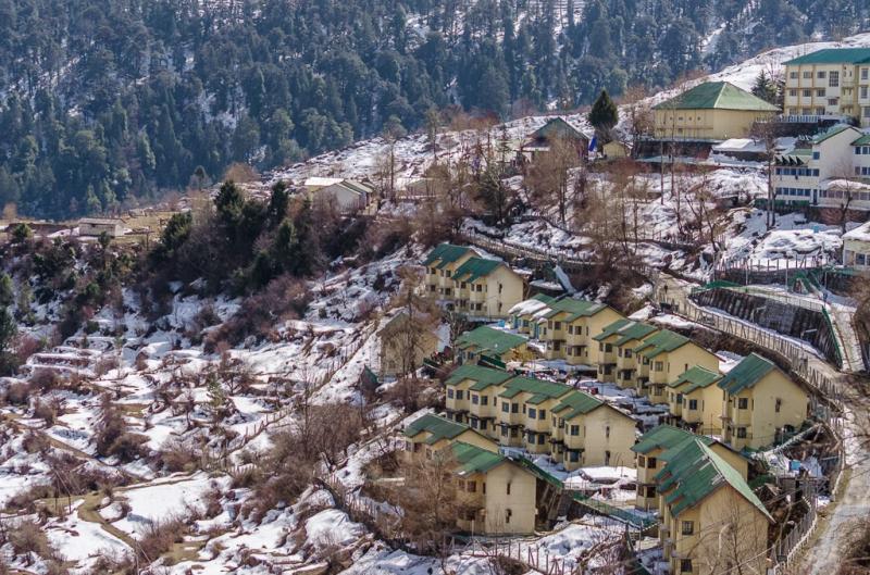 His village on the hill below his shop