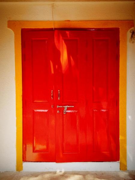The signature Red Door of the Hostel, a backpackers hostel in India