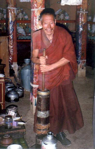 Monk churning butter in Gur Gur