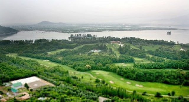 The beautiful golf course of Kashmir with a vie of the Dal lake
