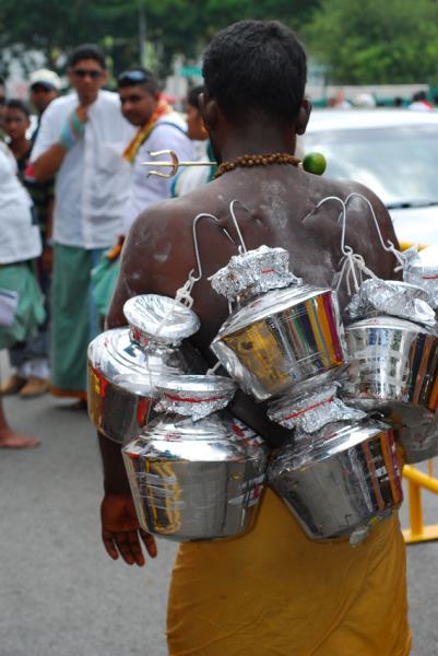 A man carrying pots pierced on to his back on Thaipusam -  Festivals of Tamil Nadu 