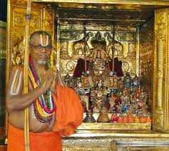 A priest beside a decorated deity