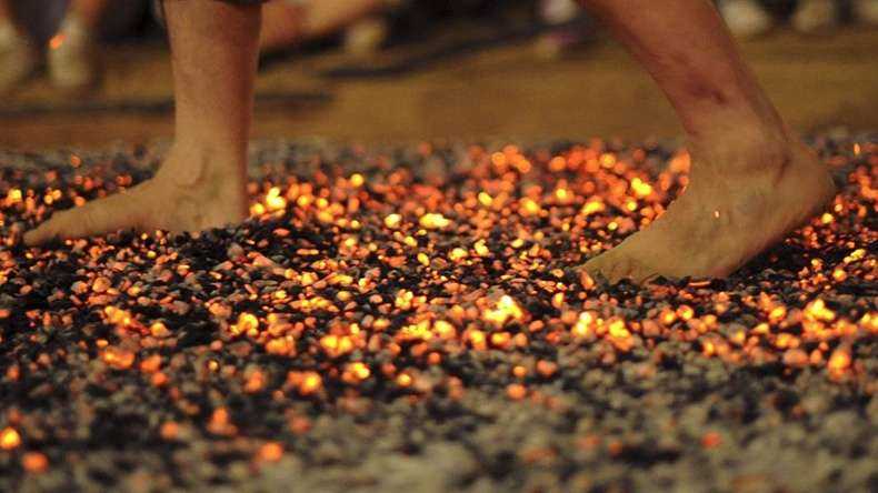 Devotees walking on hot coal during the festival