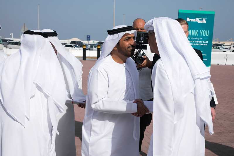 Men in UAE greeting each other with a steady handshake