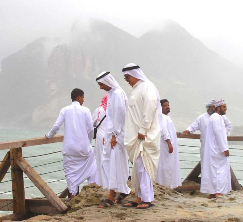 Arab men attired in long Kanduras