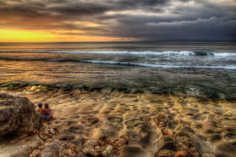 Couple watching a sunset in Bali, Indonesia