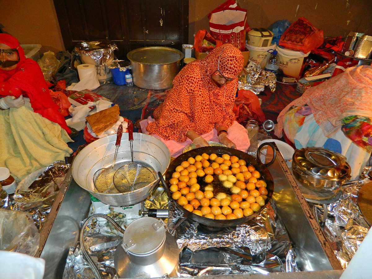 A woman cooking food using traditional recipe at UAE Stands Dubai Global Village