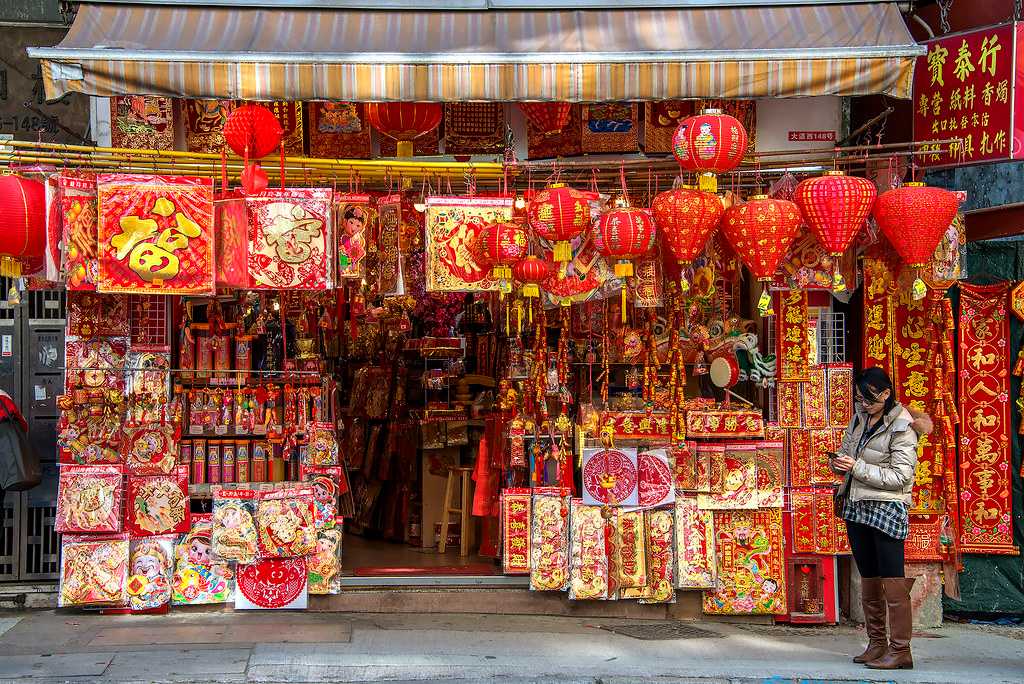 Traditional red velvet paper patterns and lanterns being sold during the Chinese New Year in Hong Kong