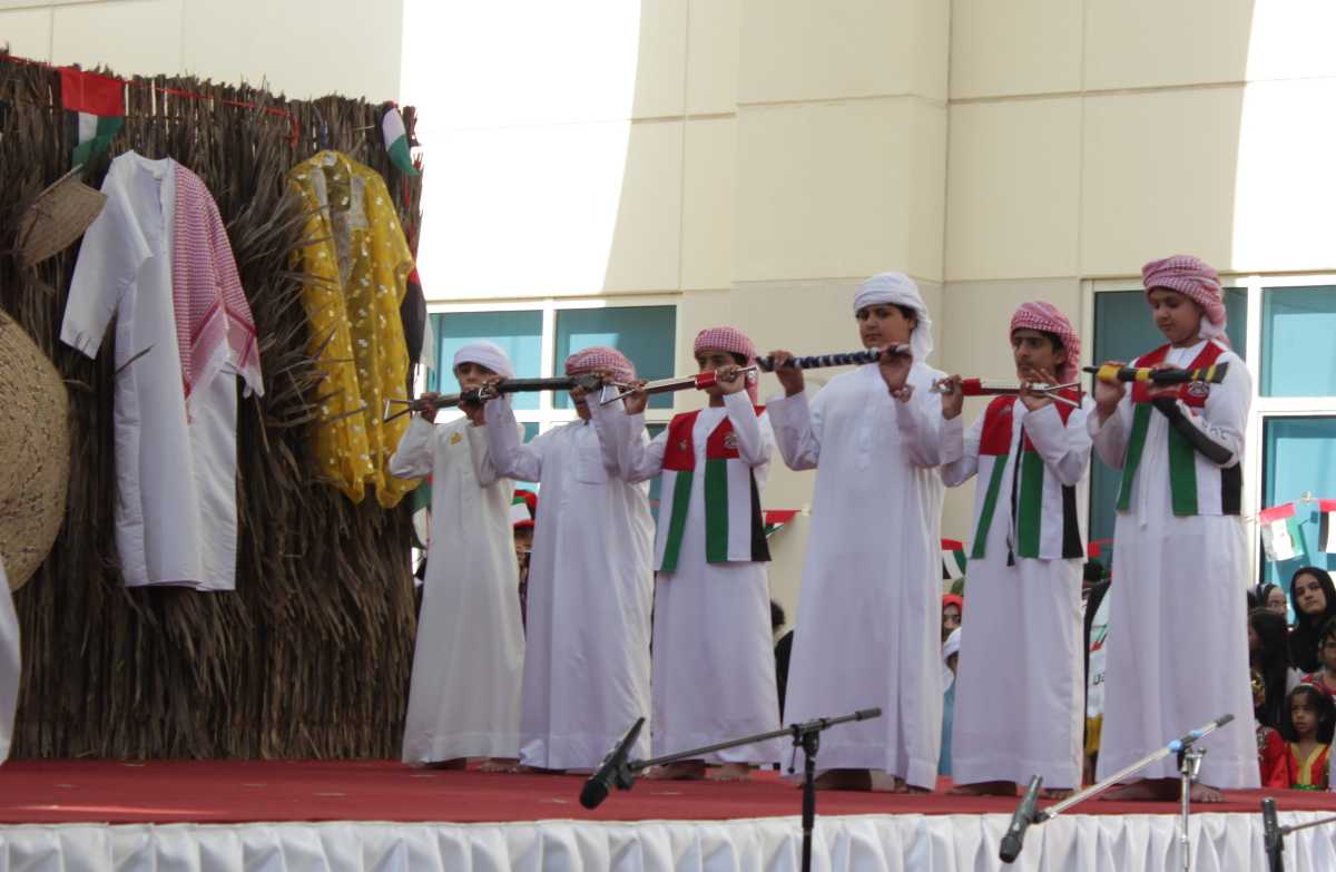 Children performing the famous Yowla dance, that involves spinning and throwing a rifle while rhythmically moving to music.