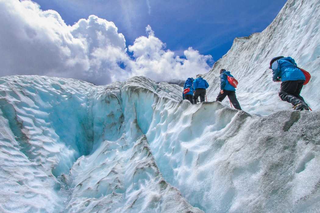 group of men ascending during the snow trek