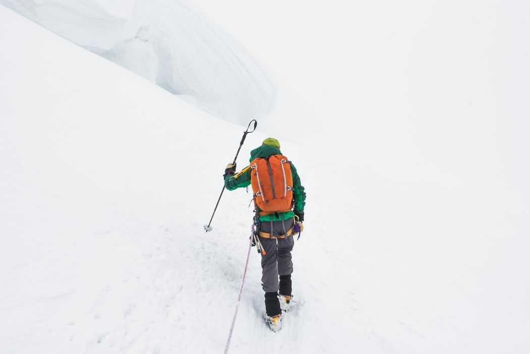 Man trekking in the Indian Himalayas under heavy snowfall