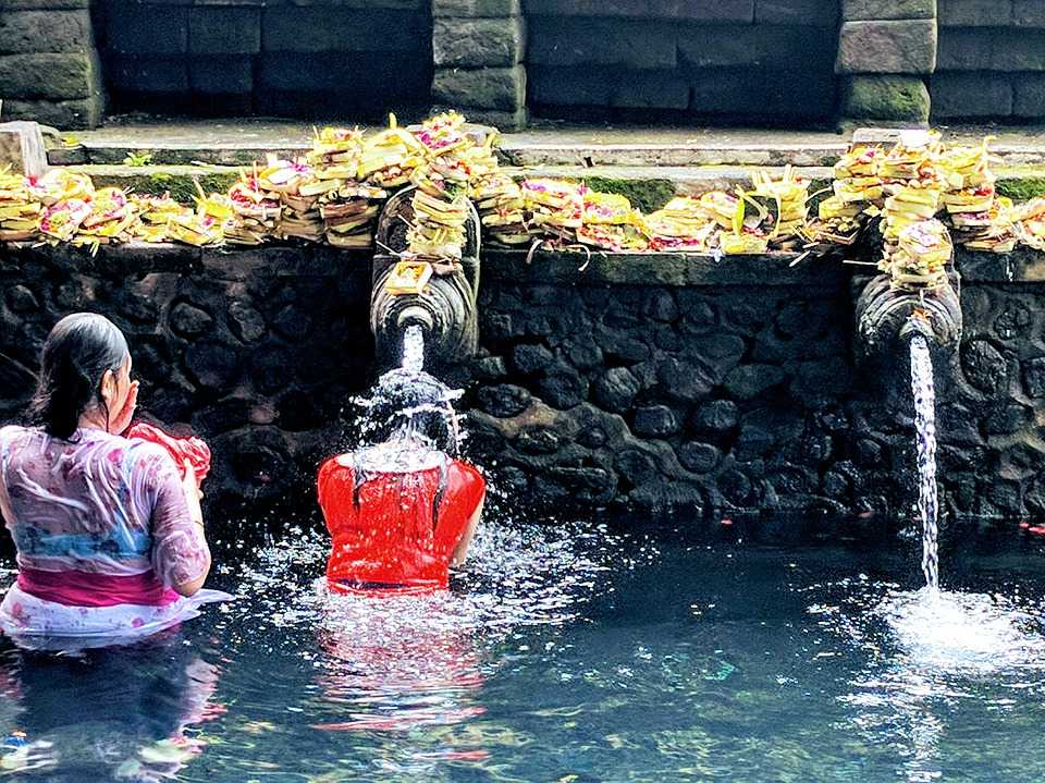 Devotees at Tirta Empul, one of the most famous and iconic Hindu Temples in Bali