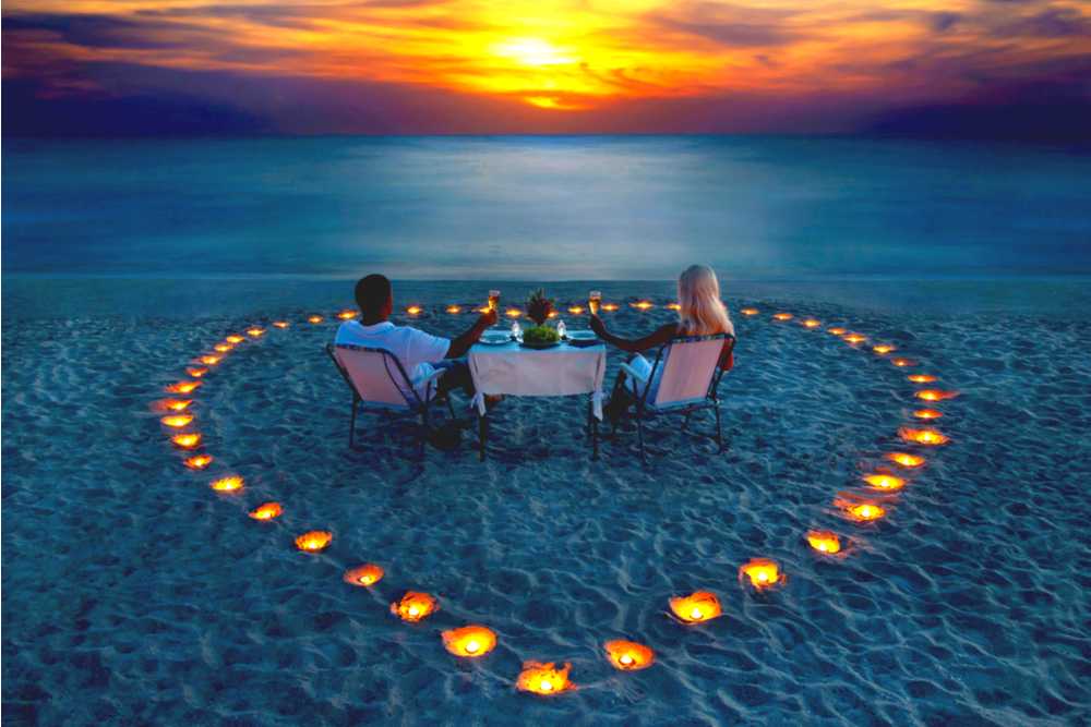 couple having a romantic dinner on a beach